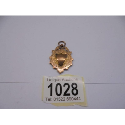 1028 - A 9ct gold watch fob, 6.9 grams.