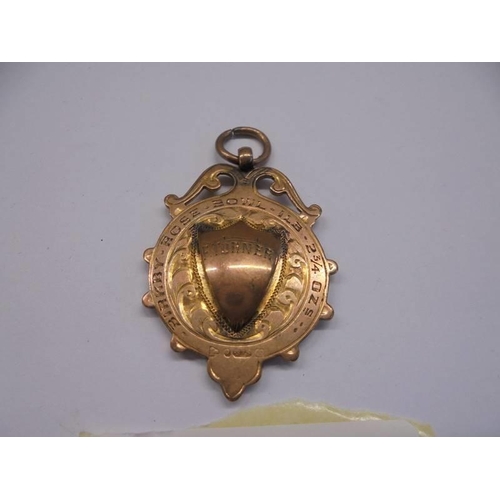 1028 - A 9ct gold watch fob, 6.9 grams.