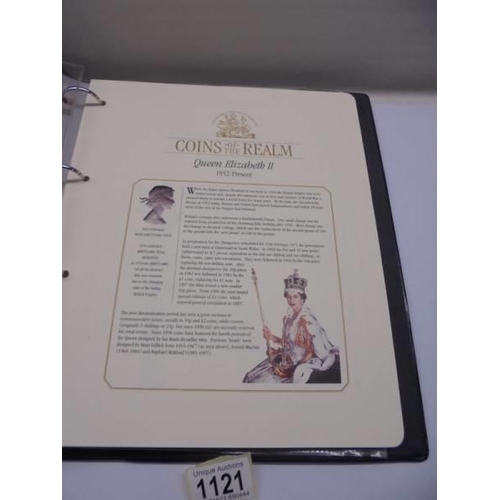 1121 - A Coins of the Realm folder with Queen Elizabeth II cover, D Day cover and replica newspaper.