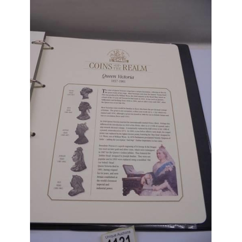 1121 - A Coins of the Realm folder with Queen Elizabeth II cover, D Day cover and replica newspaper.