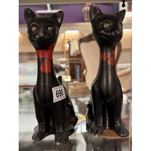 690 - A pair of vintage long neck ceramic cat ornaments. Height 23.5cm