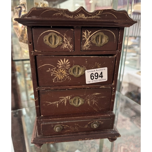 694 - A vintage lacquered chest of drawers jewellery / trinket box