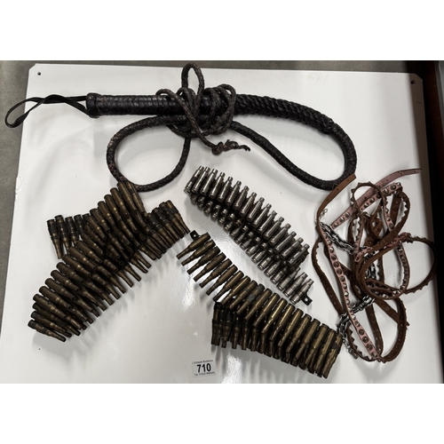 710 - A quantity of machine gun belts & A vintage whip