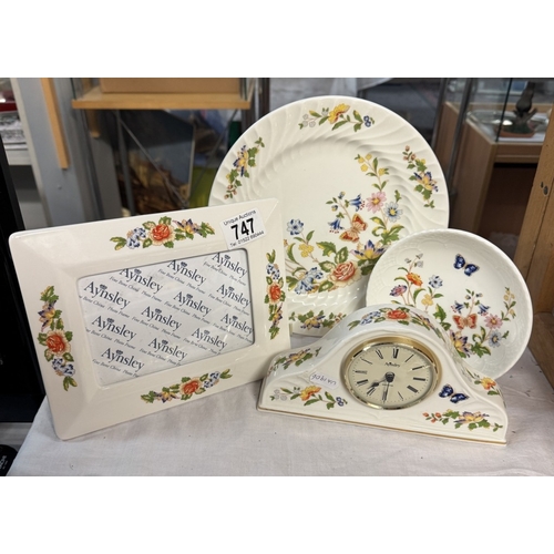 747 - An Aynsley clock, picture frame & 2 plates