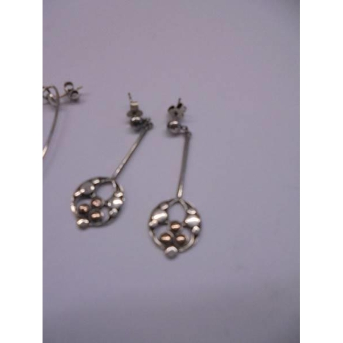 1032 - Three pairs of silver earrings.