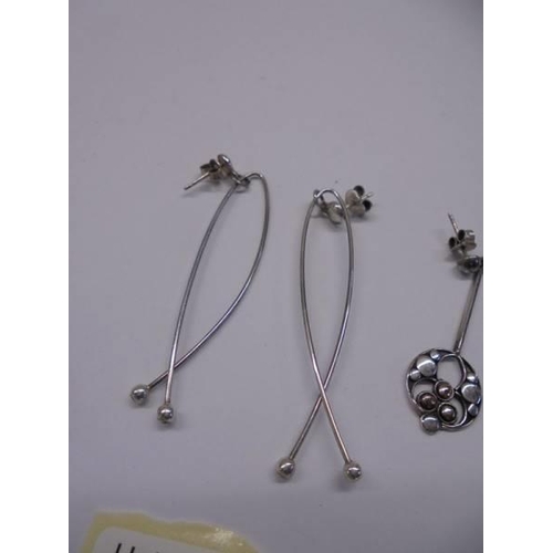 1032 - Three pairs of silver earrings.