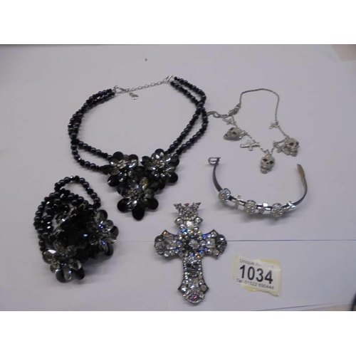 1034 - A Butler & Wilson necklace with matching earrings, a skull necklace, a skull bracelet and a cross pe... 