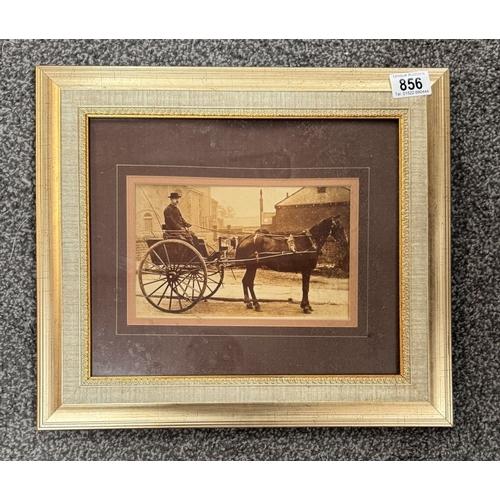 856 - A framed Sepia photo print of a gent on a trap with horse