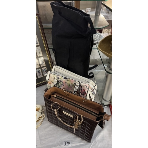 879 - An RJR John Rocha back pack & 2 Lovely ladies bags by Fiorelli & River Island in as new condition