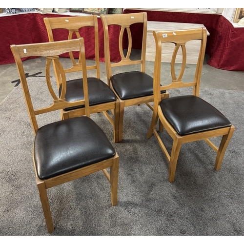 913 - 4 oak convex strut back chairs with leatherette seats.