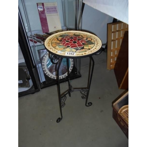 1352 - A wrought iron table with mosaic top. COLLECT ONLY.