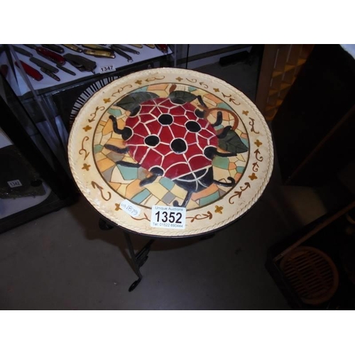 1352 - A wrought iron table with mosaic top. COLLECT ONLY.