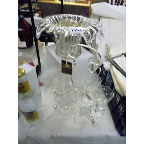 1362 - A glass rose bowl and six glasses on a plated stand.