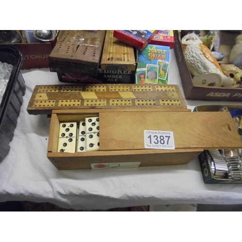 1387 - A mixed lot including crib boards, dominoes, pencil boxes, playing cards etc.,