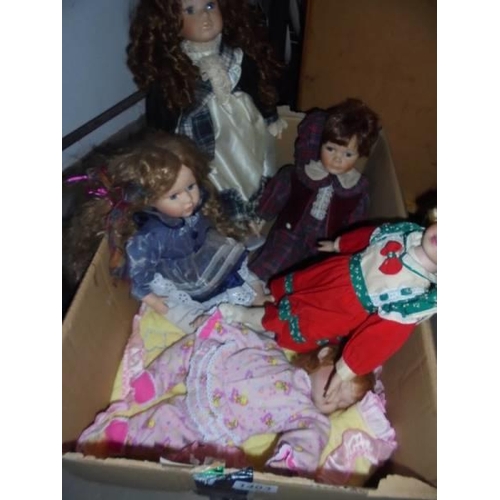 1403 - A box of assorted collector's dolls.