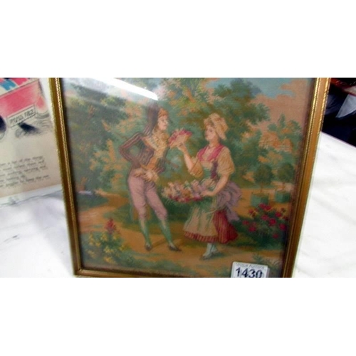 1430 - A framed and glazed silk picture of a couple in a garden.