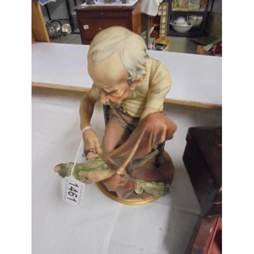 1461 - A continental porcelain figure of an elderly gentleman.