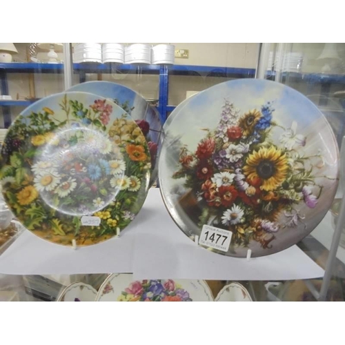 1477 - Nine floral decorated collector's plates.