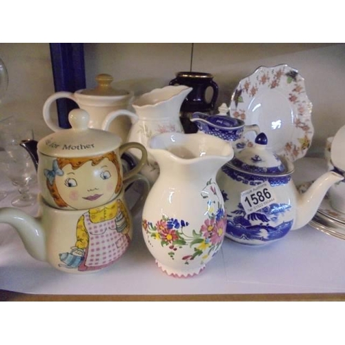 1586 - A mixed lot of teapots, jug etc.,