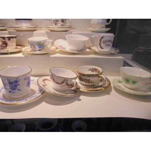 1264 - In excess of twenty miniature cups & saucers including Royal Crown Derby, Royal Doulton, Wedgwood et... 