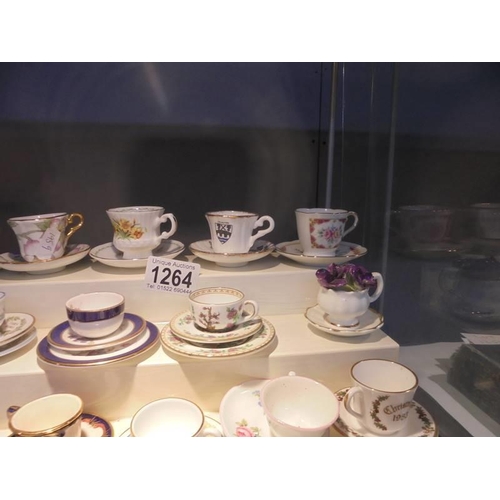 1264 - In excess of twenty miniature cups & saucers including Royal Crown Derby, Royal Doulton, Wedgwood et... 