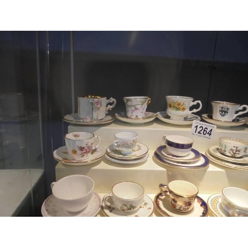 1264 - In excess of twenty miniature cups & saucers including Royal Crown Derby, Royal Doulton, Wedgwood et... 