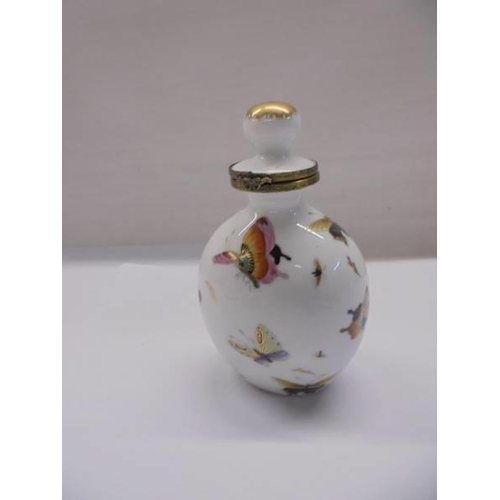 1273 - Four porcelain pill/trinket boxes and a porcelain scent bottle.