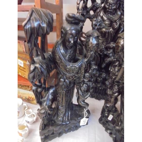 1277 - A tall pair of Oriental carved wood Figures and a taller example. COLLECT ONLY.