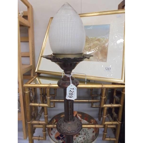 1289 - A tall brass pricket lamp with holophane acorn shade, 75 cm tall. COLLECT ONLY.