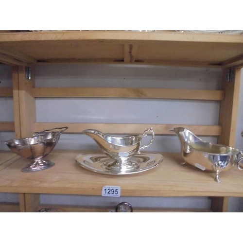 1295 - A good lot of silver plate including cruet, sauce boats, cake stand, napkin rings, basket etc.,