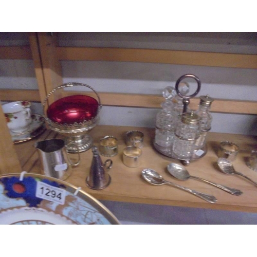 1295 - A good lot of silver plate including cruet, sauce boats, cake stand, napkin rings, basket etc.,