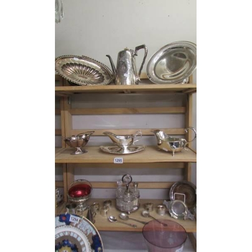 1295 - A good lot of silver plate including cruet, sauce boats, cake stand, napkin rings, basket etc.,