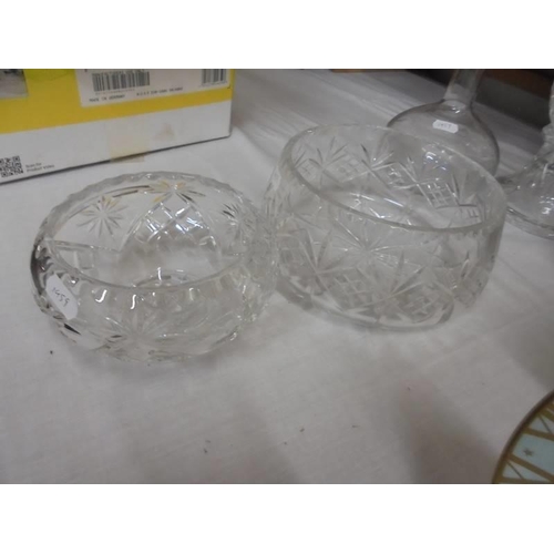 1296 - A cut glass candle lamp, two cut glass bowls and an etched decanter, COLLECT ONLY.