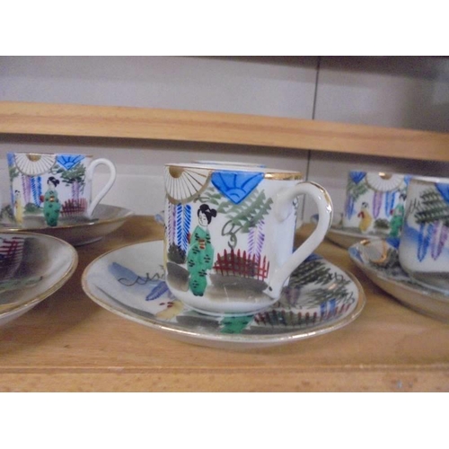 1303 - Ten Japanese porcelain coffee cups and saucers.