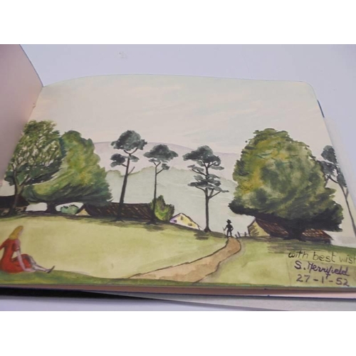 1133 - An early 20th century autograph book with paintings and drawings.