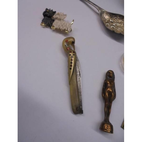 1055 - A mixed lot including novelty penknife, Zippo lighter, tea strainer, brooches etc.,