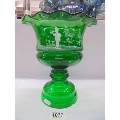 1077 - A green glass Mary Gregory style footed bowl, 25 cm tall.