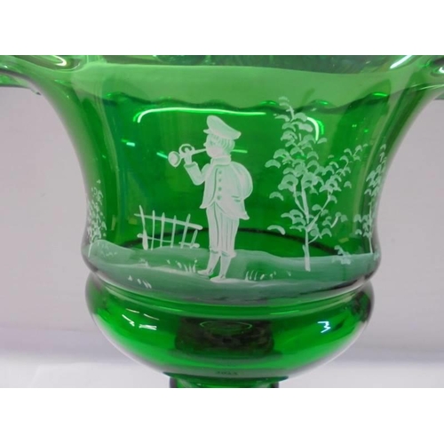 1077 - A green glass Mary Gregory style footed bowl, 25 cm tall.