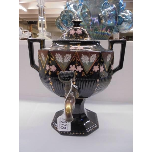 1078 - A 19th century hand painted black ceramic urn with brass tap.