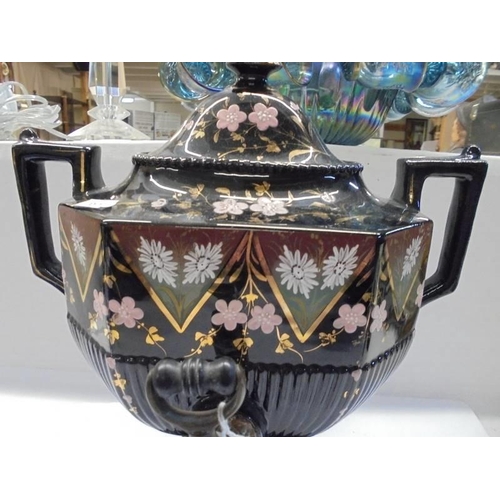 1078 - A 19th century hand painted black ceramic urn with brass tap.