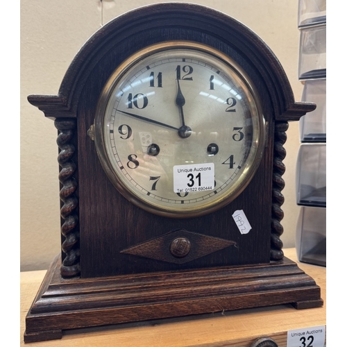 31 - A 1930s oak mantle clock with barley twist pillars, pendulum present but has no key. Last serviced 2... 