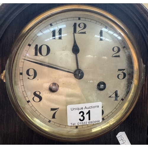 31 - A 1930s oak mantle clock with barley twist pillars, pendulum present but has no key. Last serviced 2... 