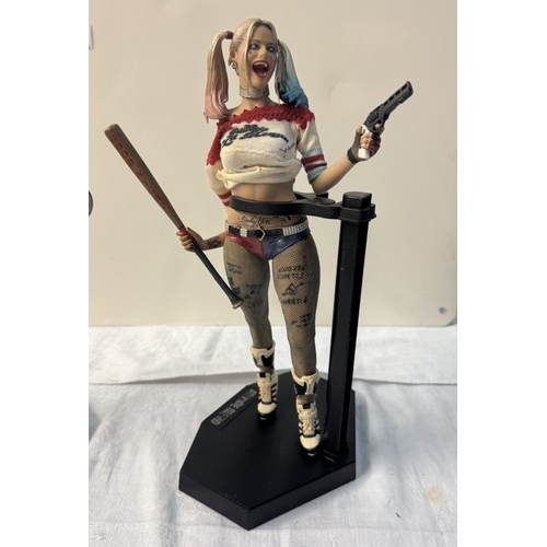 58 - A Harley Quinn standee & 4 Harley Quinn figures