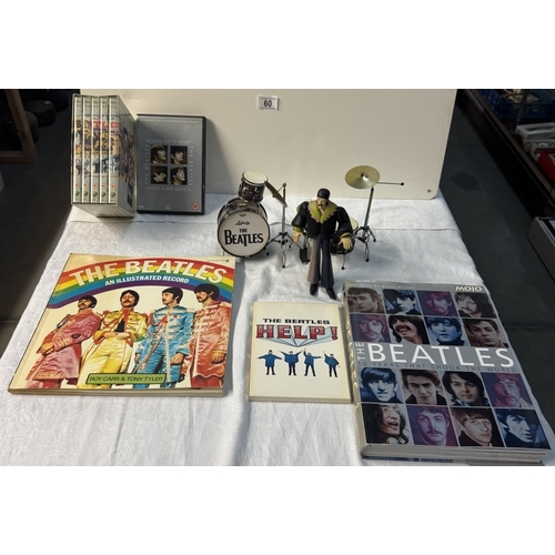 60 - A quantity of The Beatles related figures, Drum set, books, DVDs etc