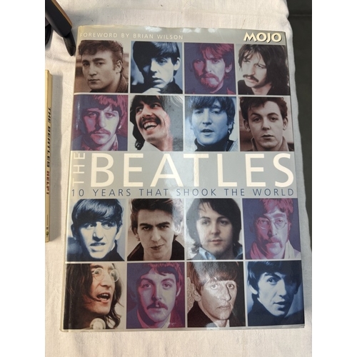 60 - A quantity of The Beatles related figures, Drum set, books, DVDs etc