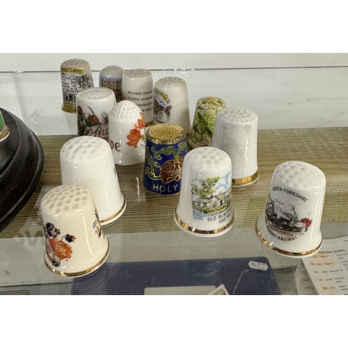 1147 - A thimble stand with 15 Royal Crown Derby thimbles & A quantity of loose thimbles. (Approximately 29... 