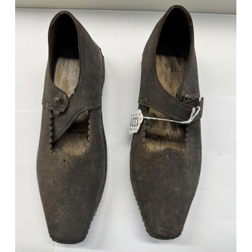 1331 - A pair of early 20th century shoes with wood and metal horse shoe shape soles and leather tops.