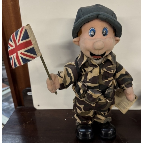 242 - A Military dressed singing Doll & a Teddy Bear