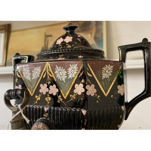 1078 - A 19th century hand painted black ceramic urn with brass tap.