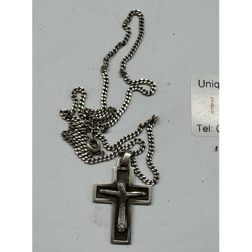 1173 - A quantity of silver items to include 2 napkin rings, a silver locket & chain & silver crucifix & ch... 